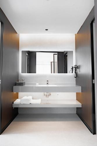 a bathroom with a sink and a mirror at Vangvieng THAVIKUN HOTEL in Vang Vieng