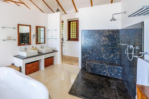 a bathroom with two sinks and a shower at Tequila Sunrise Beach Villa-Diani Beach in Diani Beach