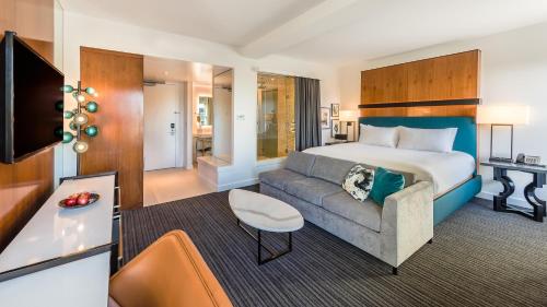 a hotel room with a bed and a couch at Andaz San Diego, By Hyatt in San Diego