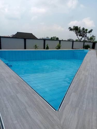 a swimming pool with blue water on a ramp at The Mimshach in Asese