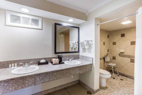 a bathroom with two sinks and a toilet at Quality Inn Escondido San Diego North County in Escondido