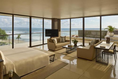 a bedroom with a bed and a view of the ocean at Alila Seminyak in Seminyak