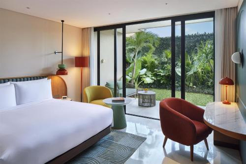 a hotel room with a bed and a desk at Kleo Seminyak, part of JdV by Hyatt in Seminyak