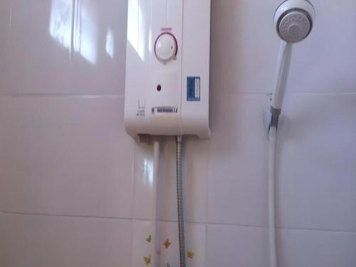 a shower head on a wall in a bathroom at Baan Gon Chompu in Suan Phung