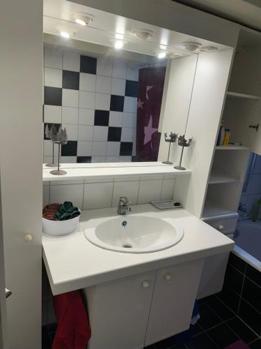 a bathroom with a white sink and a mirror at Souterrain Zimmer mit Sauna in Klosterlechfeld