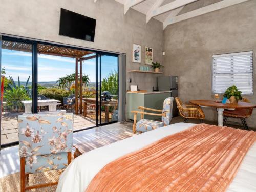 a bedroom with a bed and a view of a patio at L'abri in Langebaan