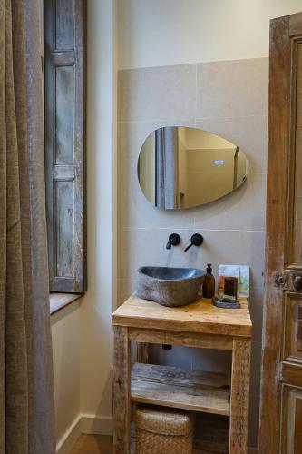 a bathroom with a sink and a mirror at Maison Constant - L'Erable in Autun