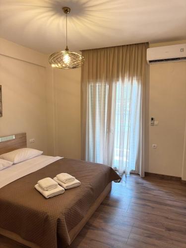 a bedroom with a bed with two towels on it at Nikoletta in Katerini