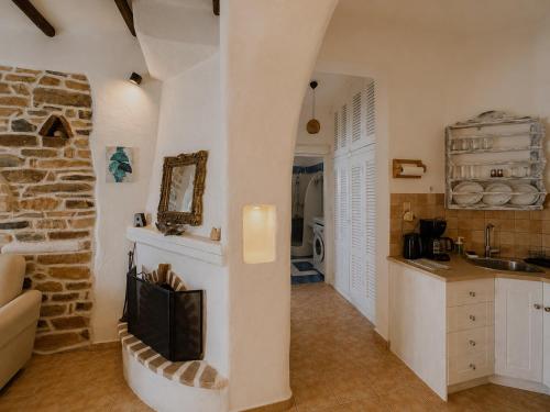 a kitchen with a fireplace in the middle of a room at Atlazia Suites in Alinda