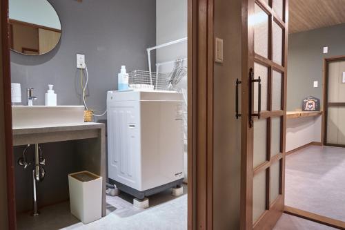 a bathroom with a sink and a white cabinet at Wan Kumano by WhyKumano in Nachikatsuura