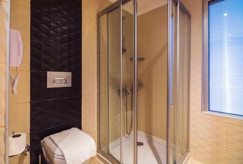 a shower with a glass door in a bathroom at Diamond Hill Resort Hotel in Alanya