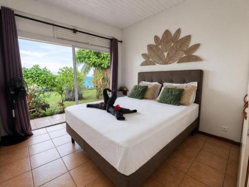 a bedroom with a large bed with a large window at PK 35 in Apomaoro