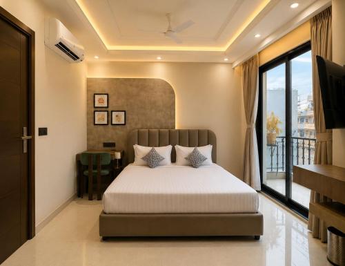 a bedroom with a bed and a balcony at Lime Tree Hotel Golf Course Road, Gurgaon in Gurgaon