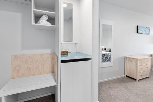 a room with a glass shelf and a desk at Quality Hotel Oceans Tutukaka in Tutukaka