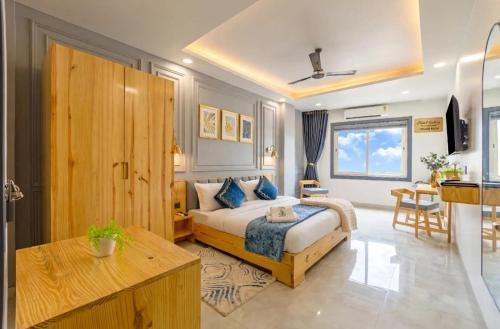 a hotel room with a bed and a table at Hotel Donland in Gwalior
