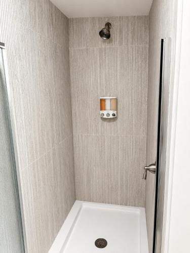 a bathroom with a shower with a toilet and a camera at The Riverwood Retreat in St. Charles