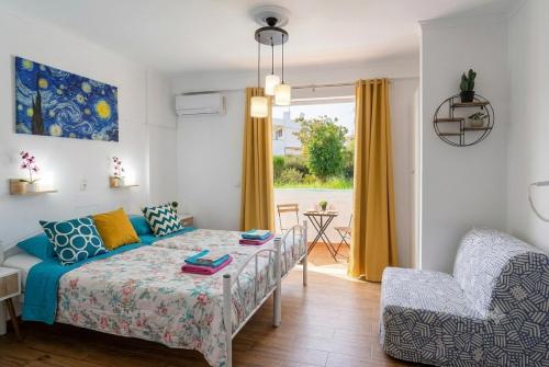a living room with a bed and a couch at Kosinmyheart Apartment 11 & Studio10 in Kos