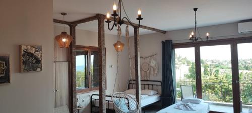 a room with a mirror and a bed and a window at Stone house with seaview in Nea Potidaea