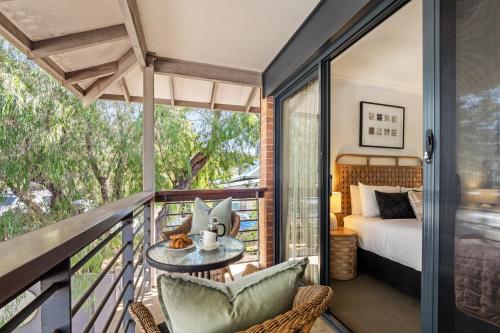 a room with a balcony with a bed and a table at Apartment 46 - Town Central - Close to Walktrails in Margaret River Town