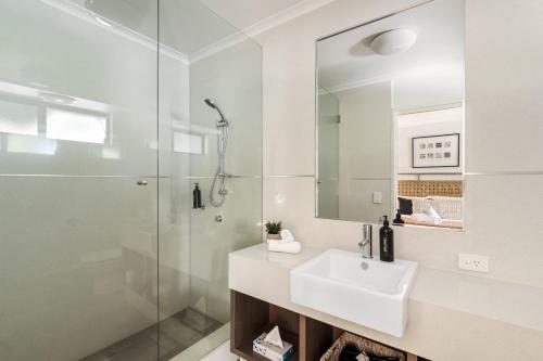 a white bathroom with a sink and a shower at Apartment 46 - Town Central - Close to Walktrails in Margaret River Town