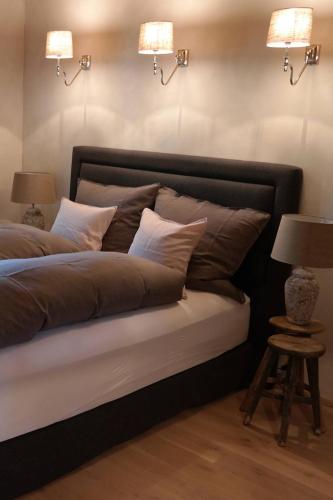 a bedroom with a bed with two lamps and two tables at Romantikhütte Rothaarsteig in Schmallenberg
