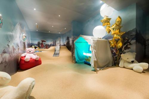 a room with teddy bears and a tent in a room at Hotel Le K2 Altitude in Courchevel