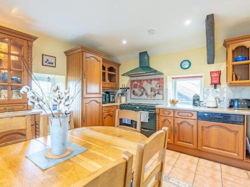 a kitchen with wooden cabinets and a wooden table at The Windmill in Castletown