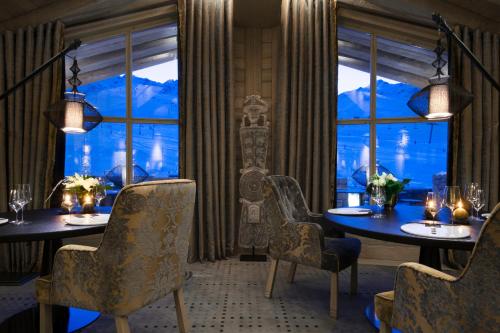 a dining room with two tables and a window at Hotel Le K2 Altitude in Courchevel