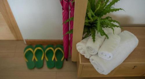 a bunch of towels on a shelf in a bathroom at Sea Coco Resort in Ban Pak Nam Khem Nu