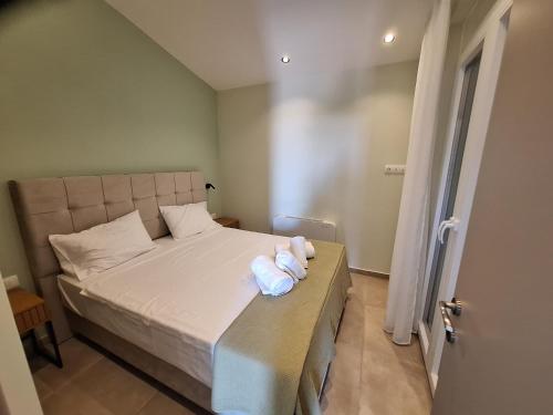 a bedroom with a bed with two towels on it at Resort Finikas in Alexandroupoli