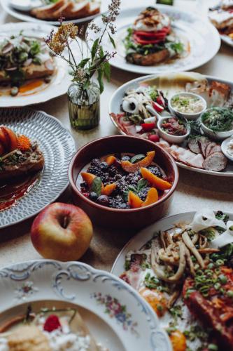a table full of plates of food on a table at InPoint Central Apartments Old Town&Kazimierz - Free Parking in Krakow