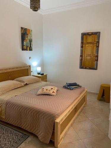 a bedroom with a large bed in a room at Najam café in Saïdia