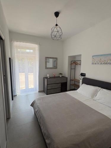 a bedroom with a large bed and a window at Poggio sul Mare in Alberese