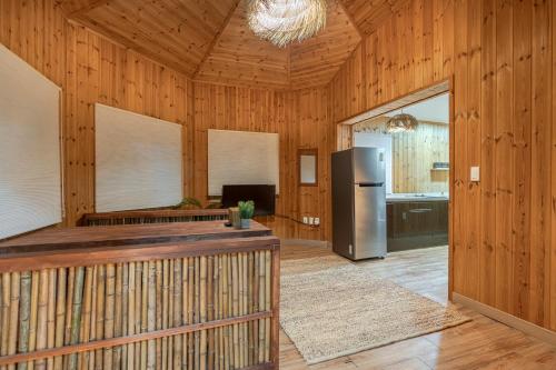 a kitchen with wooden walls and a refrigerator in a room at 감성제주스테이 in Songnang-dong