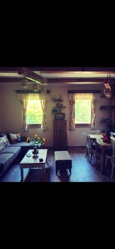 a living room with a couch and a table at Etno kuća Todorović in Smederevo