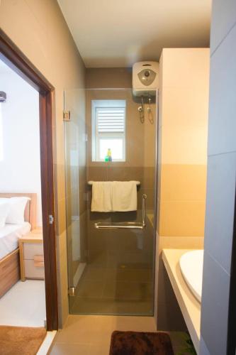 a small bathroom with a shower and a sink at Beachfront Bliss Ocean Views & Sunset Views 