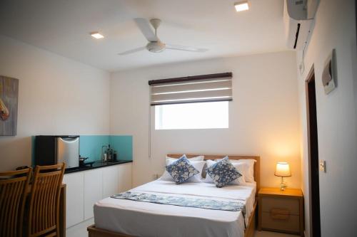 a small bedroom with a bed and a window at Beachfront Bliss Ocean Views & Sunset Views 