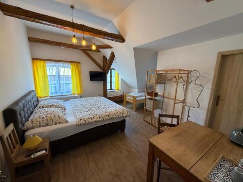 a bedroom with a bed and a table at Penzion Ambrozie in Seč