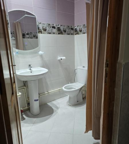 a bathroom with a sink and a toilet at Najam café in Saïdia