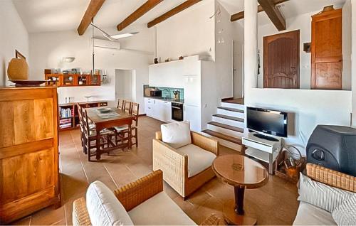 a living room with a couch and a dining room at Villa Pisicne in Mons
