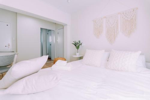 a white bedroom with a large white bed at Chic 1 Bedroom Space Near Nakasu in Fukuoka