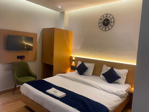a hotel room with a bed and a tv at Hotel DG Residency in Guwahati