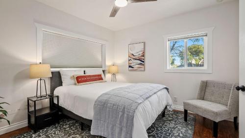 a bedroom with a bed and a chair and a window at Hideaway on Oak by AvantStay in Paso Robles