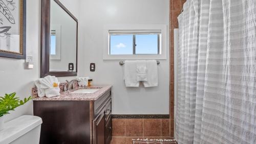 a bathroom with a sink and a shower at Hideaway on Oak by AvantStay in Paso Robles