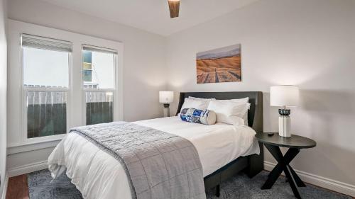 a white bedroom with a bed and a window at Paso on Oak by AvantStay in Paso Robles