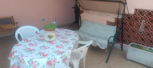 a table in a room with a bed and a table with a plant at Affittacamere Casa Sermide in Caniparola di Fosdinovo