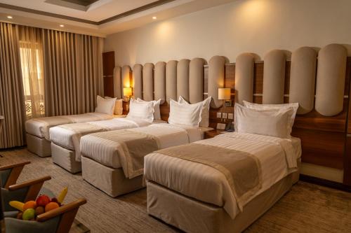 a hotel room with two beds in a room at Bosphorus Hotel Grand Safi in Medina