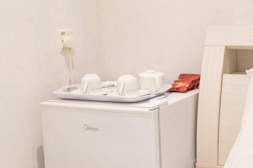 a white cabinet with a plate on top of it at Faafu View Maldives in Maldive Islands