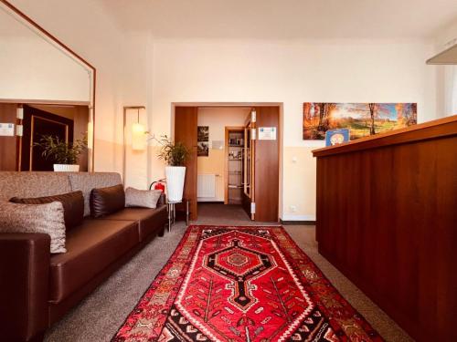 a living room with a couch and a red rug at Residenz Royal in Gmünd