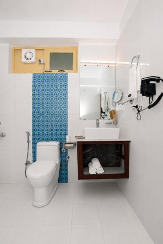 a bathroom with a toilet and a sink at Hotel Karakoram in Leh